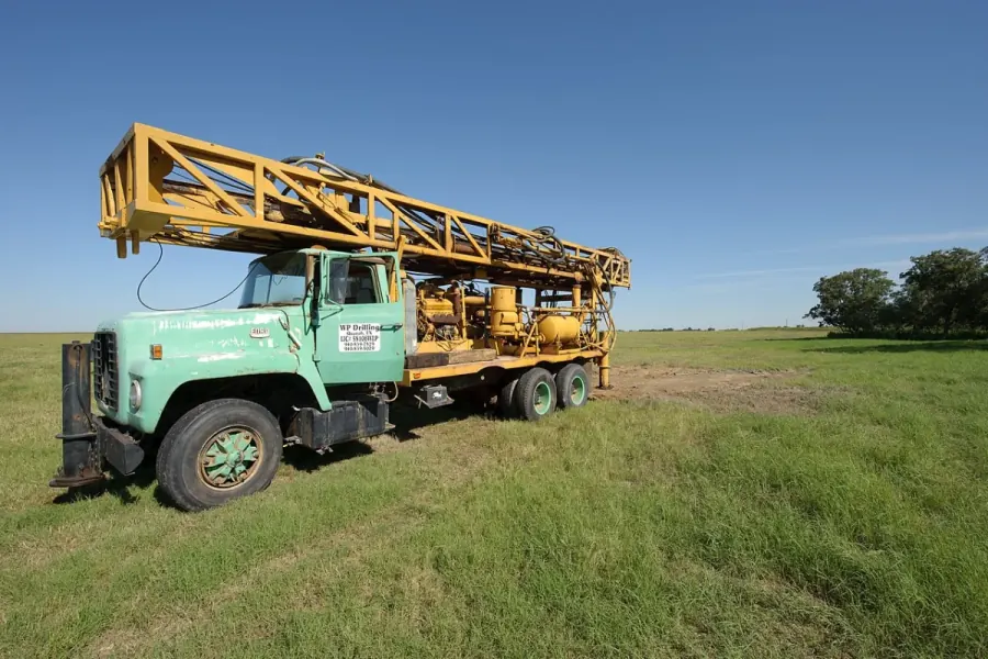 Water well drilling rig rigged up on rural Texas acreage, the same setup used on El Paso County properties