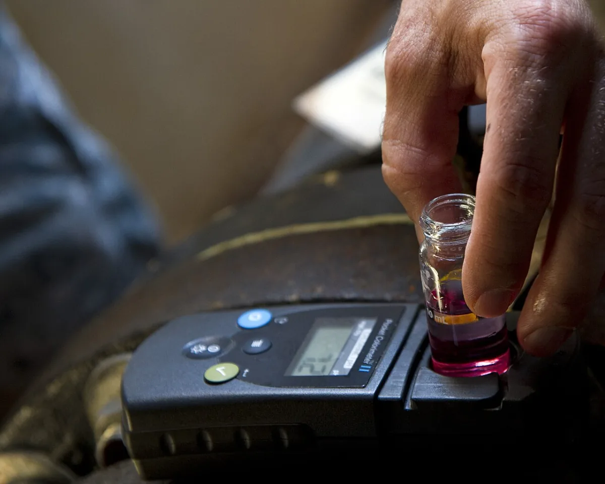 Colorimeter reading a treated water sample during a well water test in El Paso TX